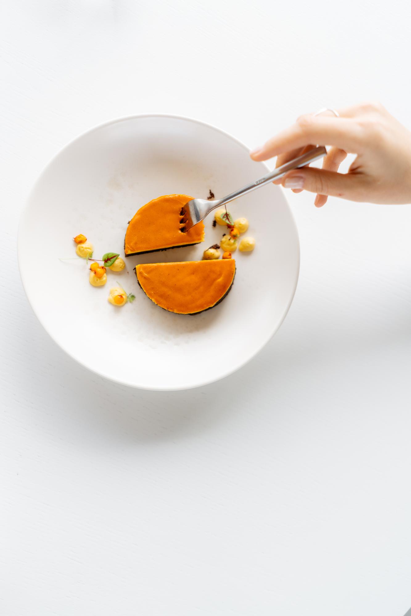 chef arranging a plated dish on a modern counter